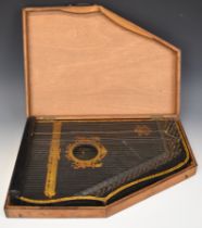 Oscar Schmidt Menzenhauer guitar zither with ebonised finish and ornate gilt decoration, in wooden
