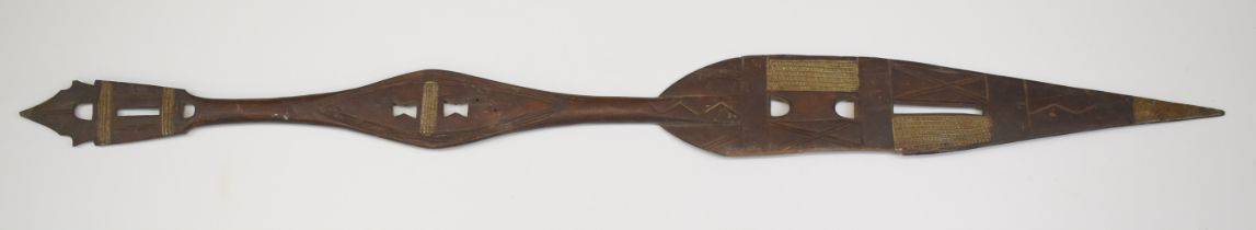 Tribal ceremonial paddle with pierced and carved decoration, 121cm long.