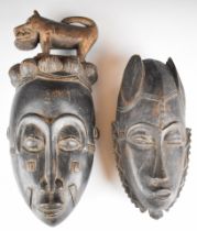 Two carved African tribal masks probably Yaure, Cote d'Ivoire / Ivory Coast, tallest 40cm