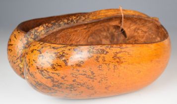 A coco de mer seed carved into a trug or similar carrier, 30x23cm.