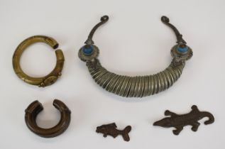 A collection of tribal jewellery including Ashanti gold weights formed as a fish and a crocodile