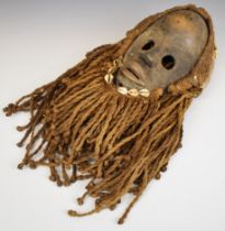 19th / 20thC African carved tribal mask with shell and hemp rope decoration, Dan, Cote d'Ivoire /