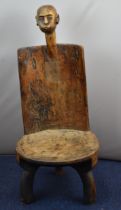 African tribal Zarano three legged chair with carved bust surmount and geometric decoration,