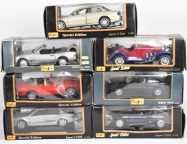 Seven 1:18 scale Maisto diecast model sports cars to include BMW 850i, Maclaren F1 and Mercedes-Benz