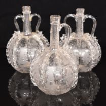 Three of Victorian glass decanters, all with engraved windmills, ships and vines, tallest 24cm