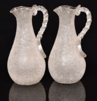 Pair of Victorian crackle glass jugs with ice cooling compartments and applied twist handles, 29cm