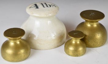 Four bun weights comprising a ceramic 4lb example and a run of three from 4 down to 1lb brass or