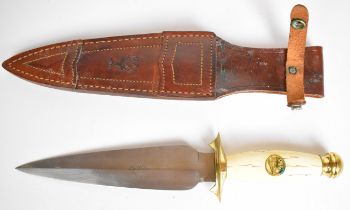 Muela hunting knife with 21cm double edged blade, brass guard and pommel, with leather sheath.