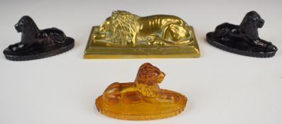 Four various 19thC paperweights all in the form of recumbent lions, three pressed glass, the