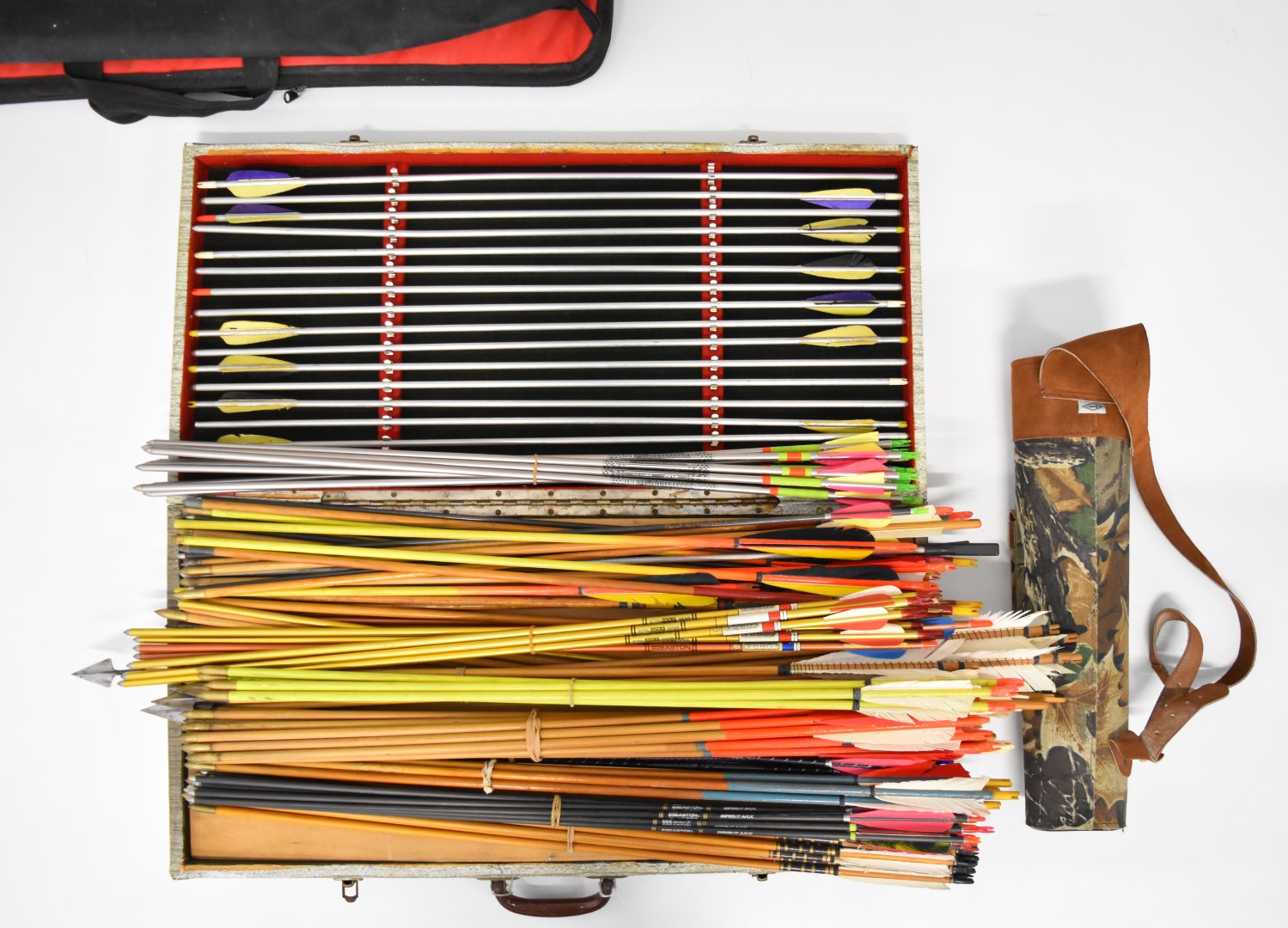 Over 100 archery arrows including aluminum and wooden examples, some in