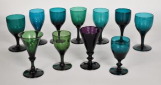 Eleven Bristol style late 18th/ early 19thC green and amethyst glass drinking glasses, some with