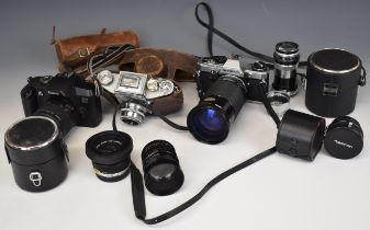 Three 35mm SLR cameras comprising Olympus OM10 with Olympus 1:1.8 f=50mm and Kiron 28-210mm