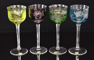 Four Moser flash overlaid hock glasses, each with engraved decoration of birds, cut stems and
