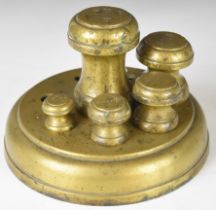 Run of brass or bronze Victorian weights contained in a circular stand, with ship and letter W for