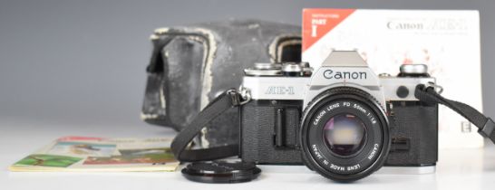 Canon AE-1 35mm SLR camera, with 50mm 1:1.8 lens and instruction manual