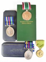 Two Civil Defence Long Service Medals, both boxed, together with a boxed Women's Voluntary Service