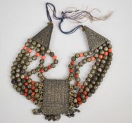 Eastern necklace made up of white metal and coral coloured glass beads