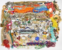 A collection of jewellery including beaded necklaces, vintage brooches, silver rings, silver chains,