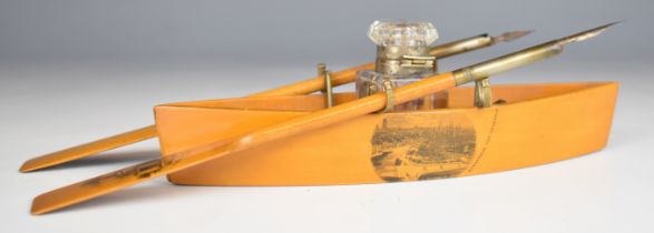 Mauchline ware novelty desk stand formed as a rowing boat, with central glass inkwell flanked by two