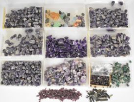 A collection of loose uncut gemstones including tourmaline (total 200ct), blue topaz, emerald,