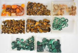 A collection of tiger's eye, malachite and amber including 29 tiger's eye cabochons (3.9 x 2.9cm),
