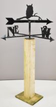 Novelty blacksmith made weather vane surmounted by an owl, on wooden base, overall height 115cm,