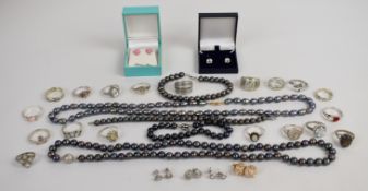 A collection of silver jewellery including 18 rings and six pairs of earrings, together with two
