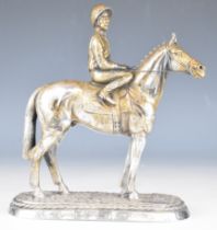 Elizabeth II novelty hallmarked silver horse and jockey on a naturalistic base, Sheffield 1987,