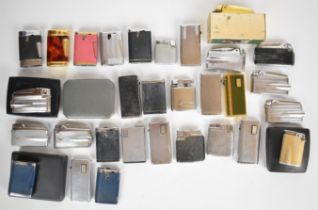 Over thirty Ronson cigarette lighters together with a box of genuine Ronson spare parts. PLEASE NOTE