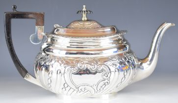 Victorian hallmarked silver teapot with embossed decoration and ebonised handle and knob,