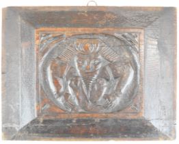 Likely 17th century carved oak panel decorated with a jester or similar contorted man, 24 x 31cm