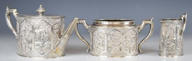 Wang Hing Chinese silver three piece tea set, with embossed scenes including buildings, people,