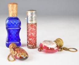 Four 19th / 20thC coloured glass scent / perfume bottles including a blue faceted example with