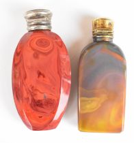 Two agate scent bottles, one with silver or similar top, the other gilt, height of tallest 6.5cm
