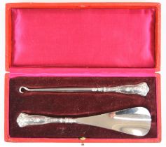 Cased Art Nouveau hallmarked silver handled button hook and shoe horn, import marks for Birmingham