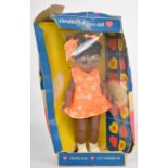 Pedigree Cleo Walker doll with black hair, brown weighted eyes, orange dress and matching