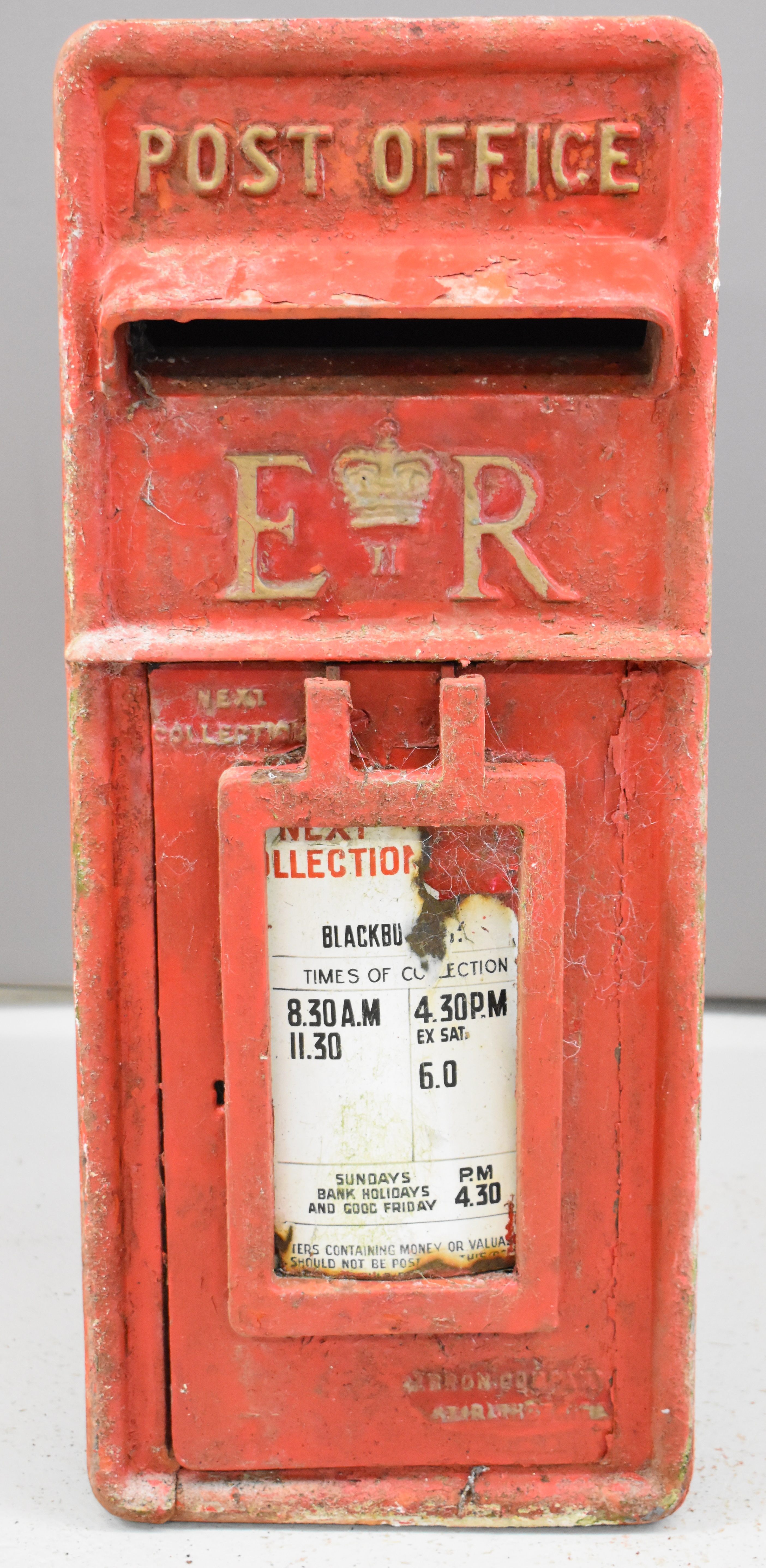 Elizabeth II cast iron and steel post box with enamel plate to front giving collection times,
