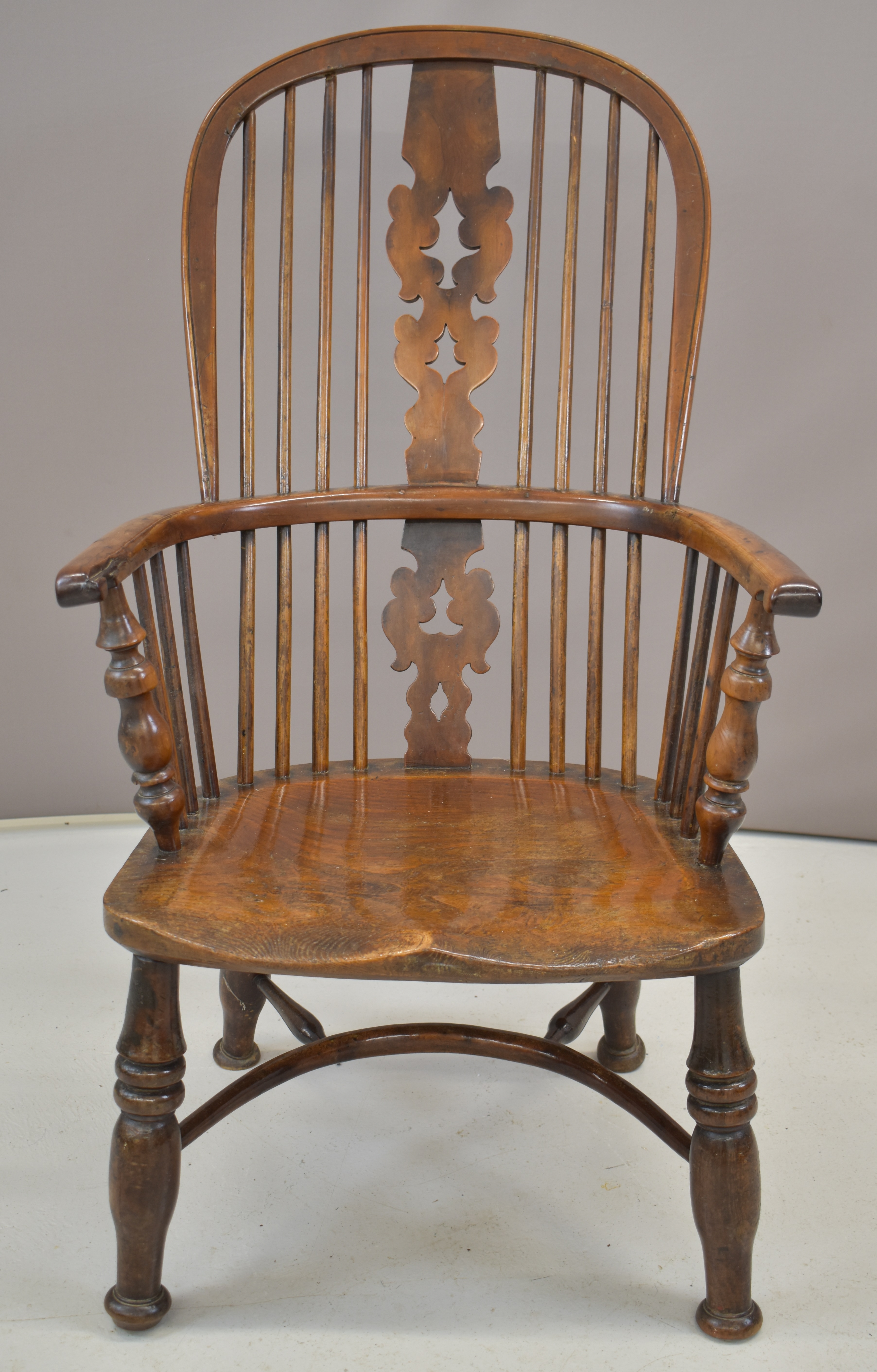 19thC elm seated Windsor armchair with pierced back splats and yew armrests