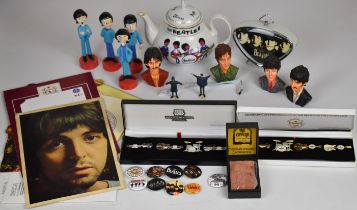 A collection of Beatles ephemera to include lead figures, resin busts, alarm clock, Cavern brick