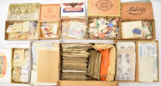 A world stamp collection in cigar boxes, including loose stamps and early mint and used world postal