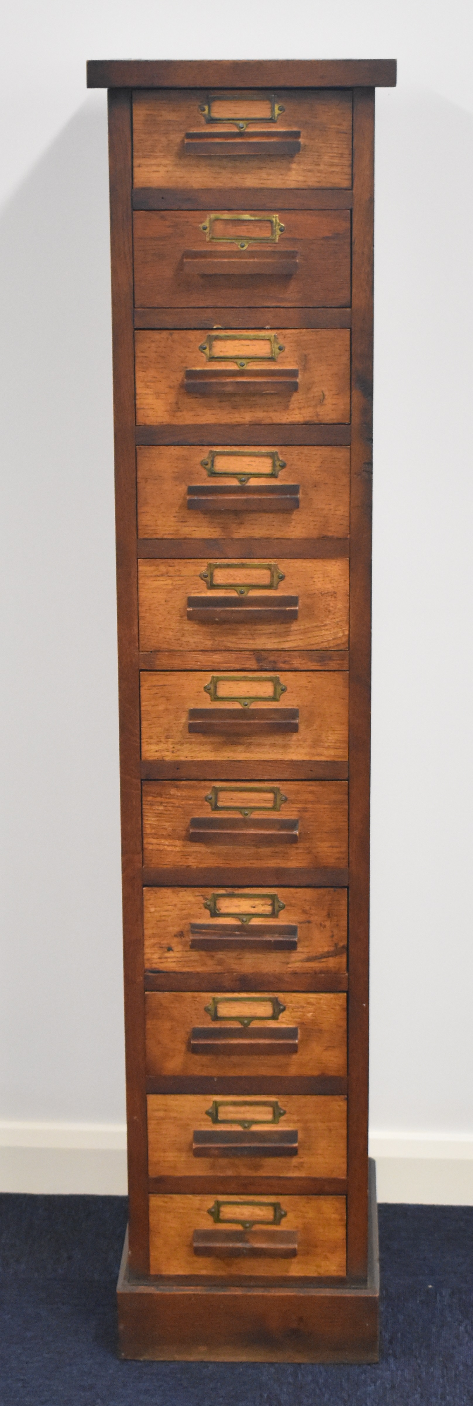 Oak collector's chest of eleven drawers with parquetry decoration, W30.5 x D40 x H147cm