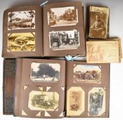 Over 420 postcards in two albums / loose and a Victorian Gothic Revival brass and oak book cover,