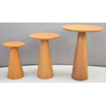 Set of three graduated mid century modern circular occasional tables with solid tapering supports,