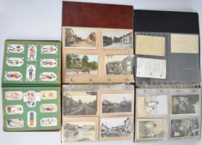 Two albums of mainly Edwardian postcards including humorous, sentimental, topographical,