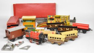 Hornby 0 gauge tinplate clockwork 0-4-0 locomotive together with carriages, goods wagons and a