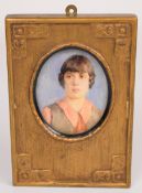 Early 20thC portrait miniature of a lady, the likely ivory panel attached to a postcard with name
