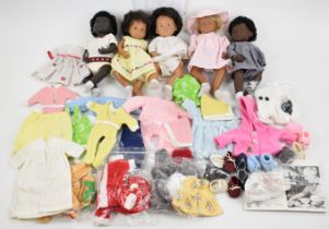 Five Gotz Sasha Baby dolls including one earlier sexed model, together with a collection of clothing