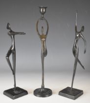 Three Bodrul Khalique bronze figures, two of dancing ladies, the other forming a candlestick, height