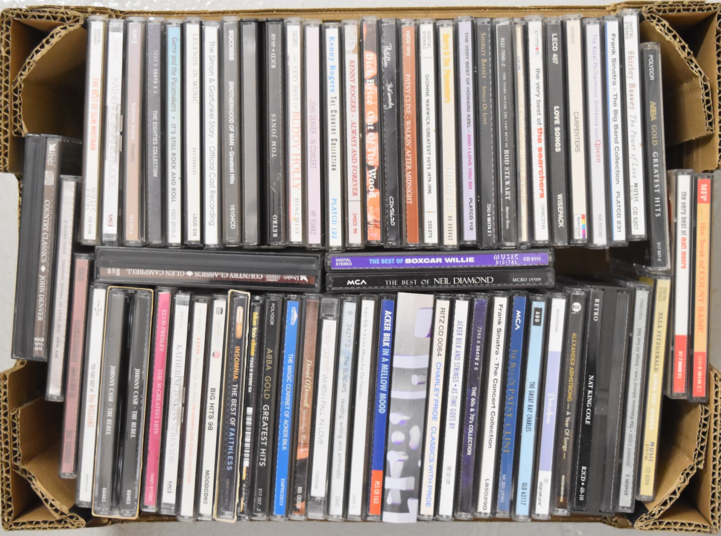 Approximately 65 mixed genre CDs including Abba, Buddy Holly, Dionne Warwick, Frank Sinatra, Ray