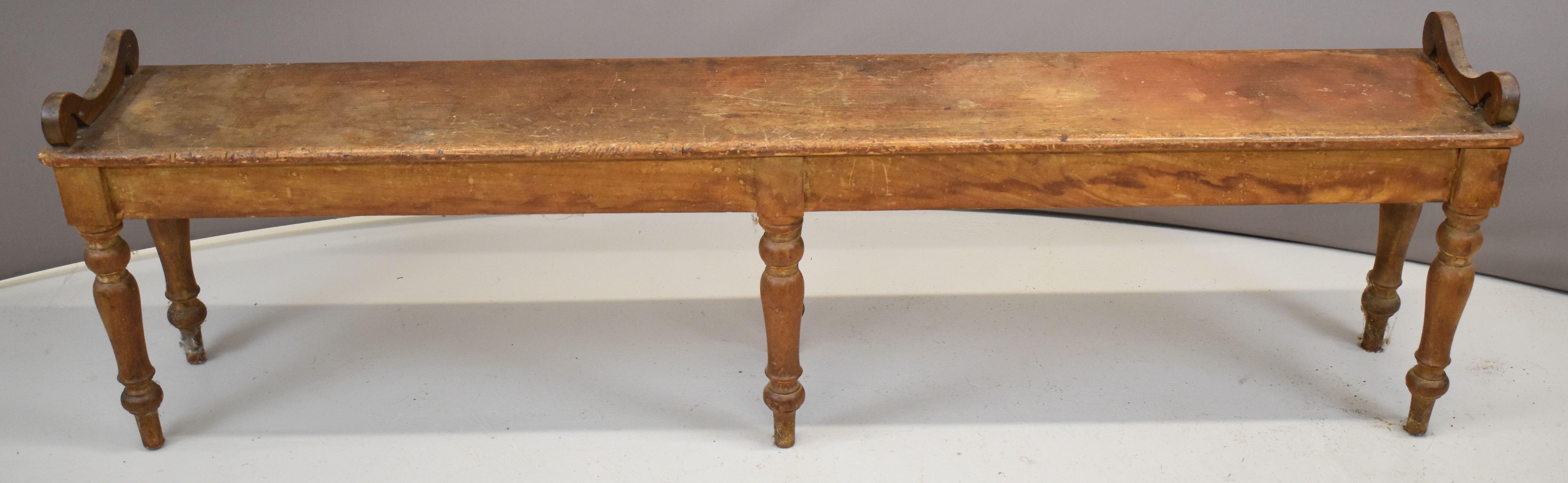 19thC ash window seat or low bench with scroll ends, raised on six turned legs, W193 x D30 x H46cm
